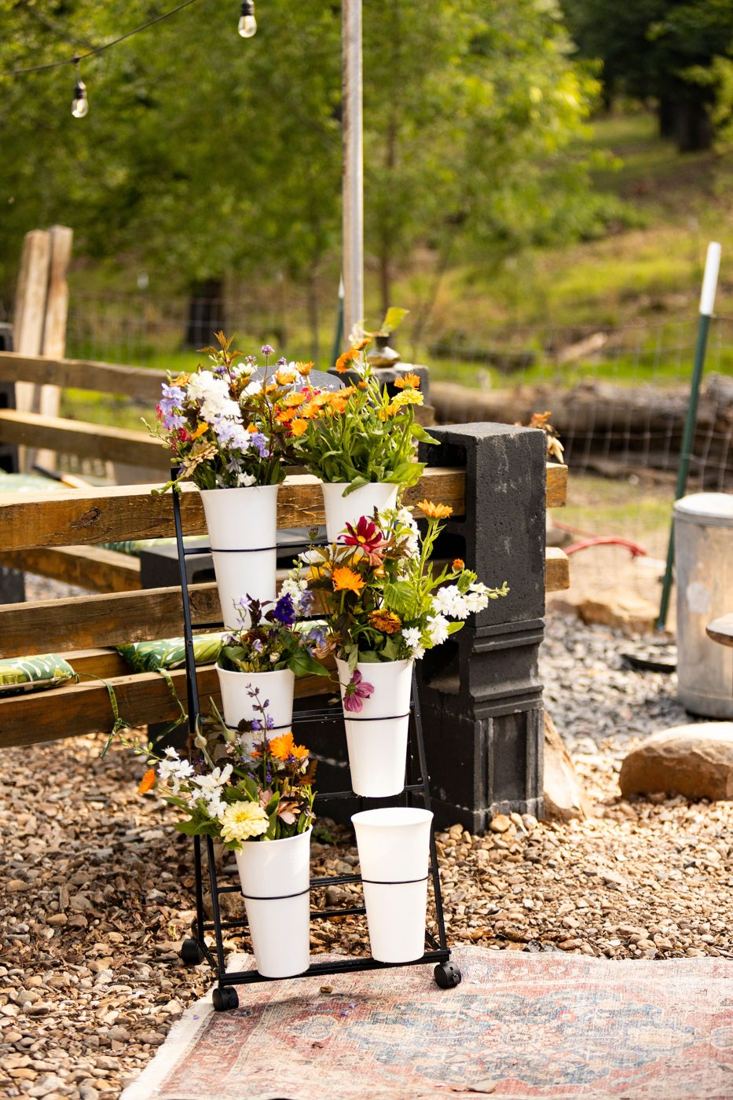 Buckets of just-cut calendula, larkspur, zinnias and cosmos ready for arranging