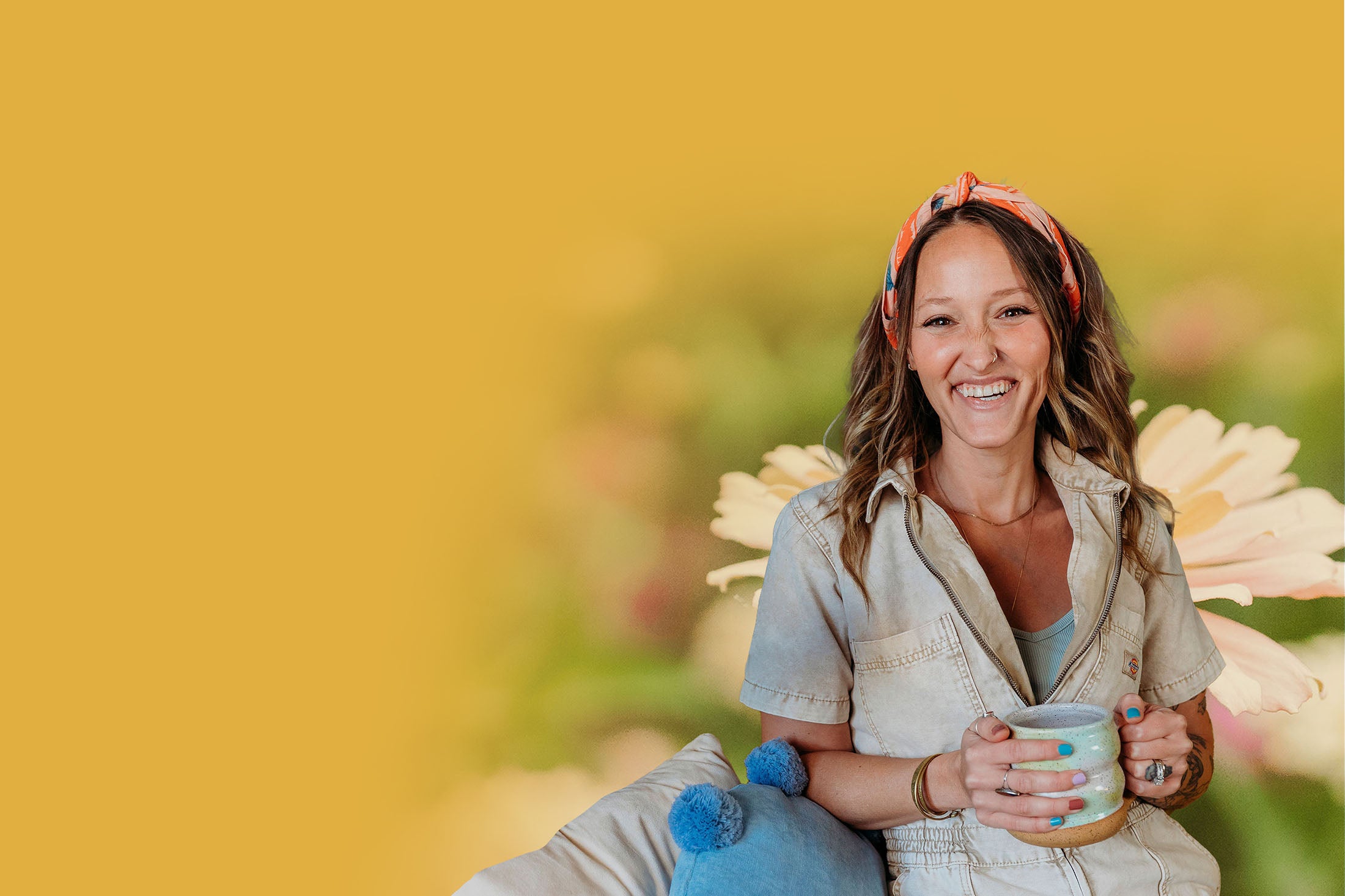 Jill smiling and holding a mug, with a yellow background of flowers